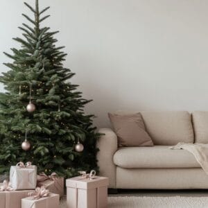 cozy living room with a decorated christmas tree and pastel gift boxes during the holiday season