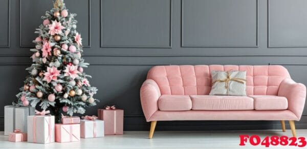 stylish pink sofa decorated for christmas with christmas tree and ornaments