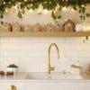 charming holiday kitchen adorned with festive greenery and decorative gingerbread houses