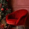 cozy red chair against a festive backdrop with christmas decorations and a tree