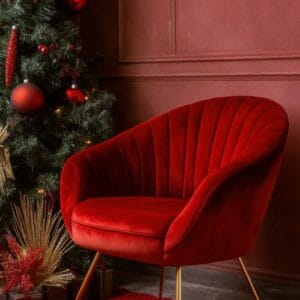 cozy red chair against a festive backdrop with christmas decorations and a tree