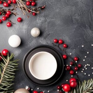 christmas ornaments and pine branch on blue background