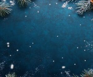 festive winter decoration with pine branches, ornaments, and falling snow on a blue background