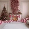 a festive living room adorned with pink and gold christmas decor and gifts for the holidays