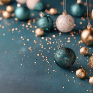 colorful christmas ornaments and glitter on dark background during holiday season