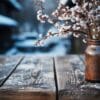 empty wooden table against a blurred winter landscape. village in the mountains. copy space. vertical format.