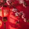 happy chinese new year, hanging beautiful lantern and flowers on red background. copy space.