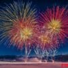 a vibrant fireworks display over a snowy landscape, creating con