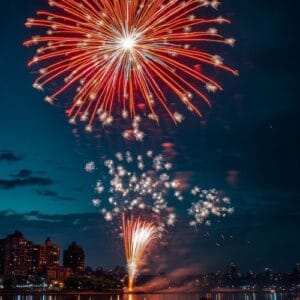 bright fireworks exploding in the night sky over a cityscape, re