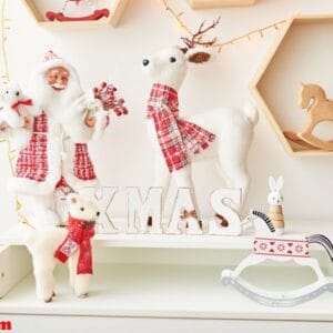 shelf with christmas figures santa and deer in children's room. christmas interior of children's bedroom. new year's decor and tree in children's playroom. ?hristmas in the nursery.