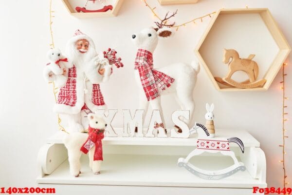 shelf with christmas figures santa and deer in children's room. christmas interior of children's bedroom. new year's decor and tree in children's playroom. ?hristmas in the nursery.