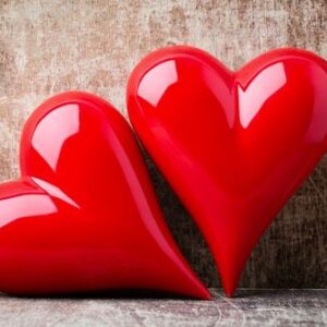 heart. red stone hearts on the wood background.