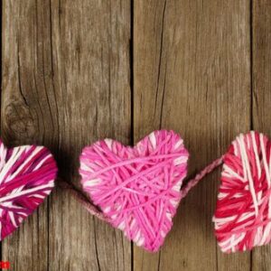 valentines day wool hearts against old wood