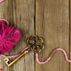 valentines day background with wool heart and key on old wood