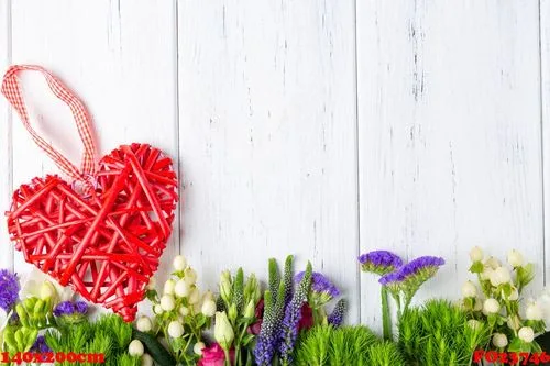 background with spring flowers and decoratiove wooden heart