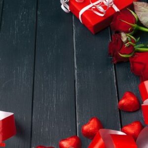 st. valentines day. red roses and gift box on wooden table