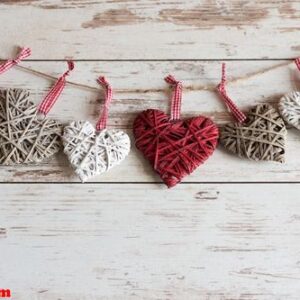 colorful wooden hearts ornament hanging on a wooden background.