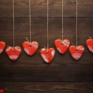 line of red gingerbreads hearts on ribbon.