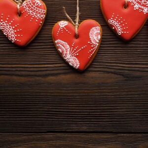 line of red gingerbreads hearts on ribbon.