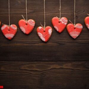 line of red gingerbreads hearts on ribbon.