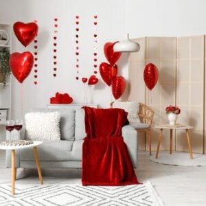 interior,of,living,room,with,sofa,,tables,and,red,balloons