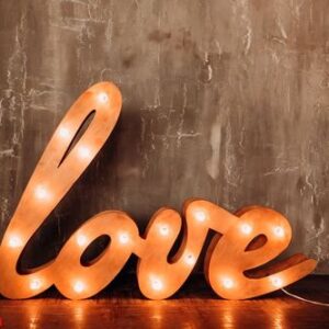 word of love. letters with flashlights. the bright word love in the interior. huge letters with light bulbs standon the floor.