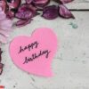 happy birthday note in heart shape paper with pink flowers